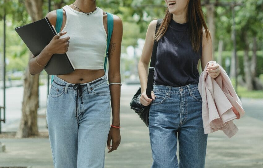 Two Young Women Walkng In The Street