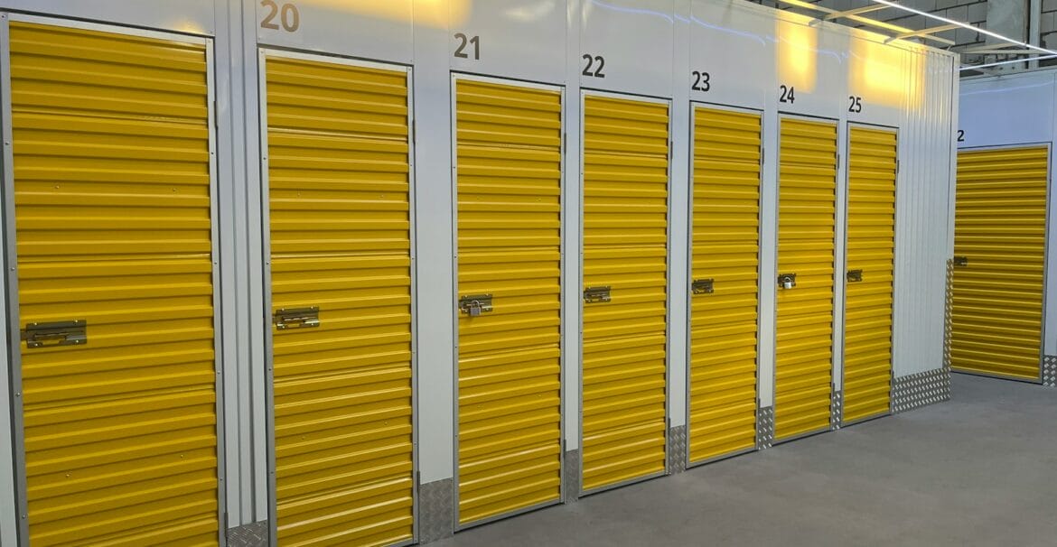a row of storage units with yellow doors